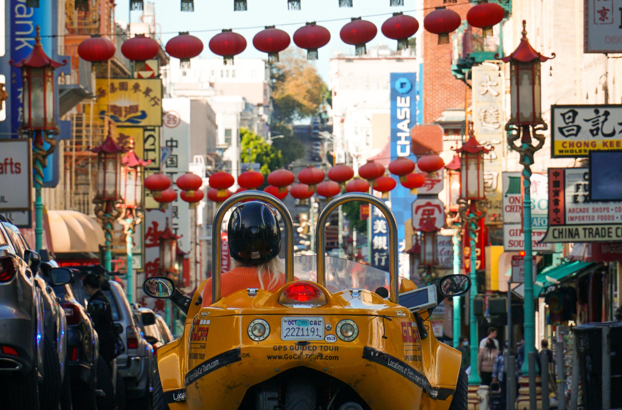 Gocar passing under Chinese lanterns in Chinatown San Francisco