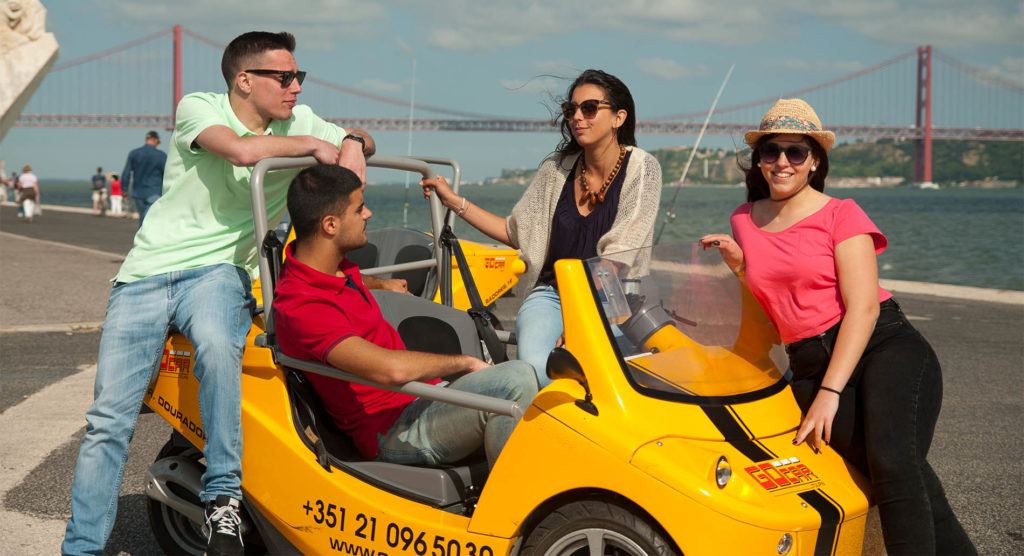 Group of People posed around a GoCar in San Francisco