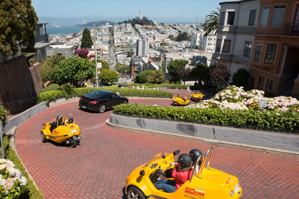 group of GoCars driving on Lombard Street in San Francisco