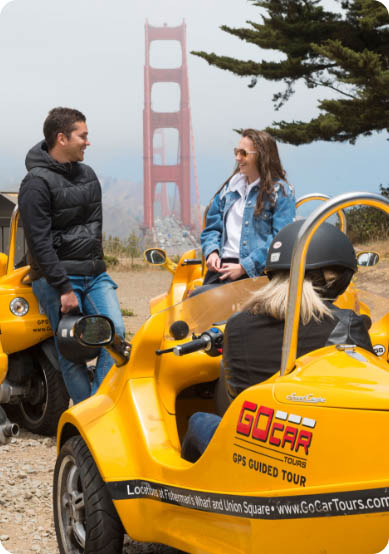 GoCar Tourists Taking a Break and Talking in Front of the Golden Gate Bridge