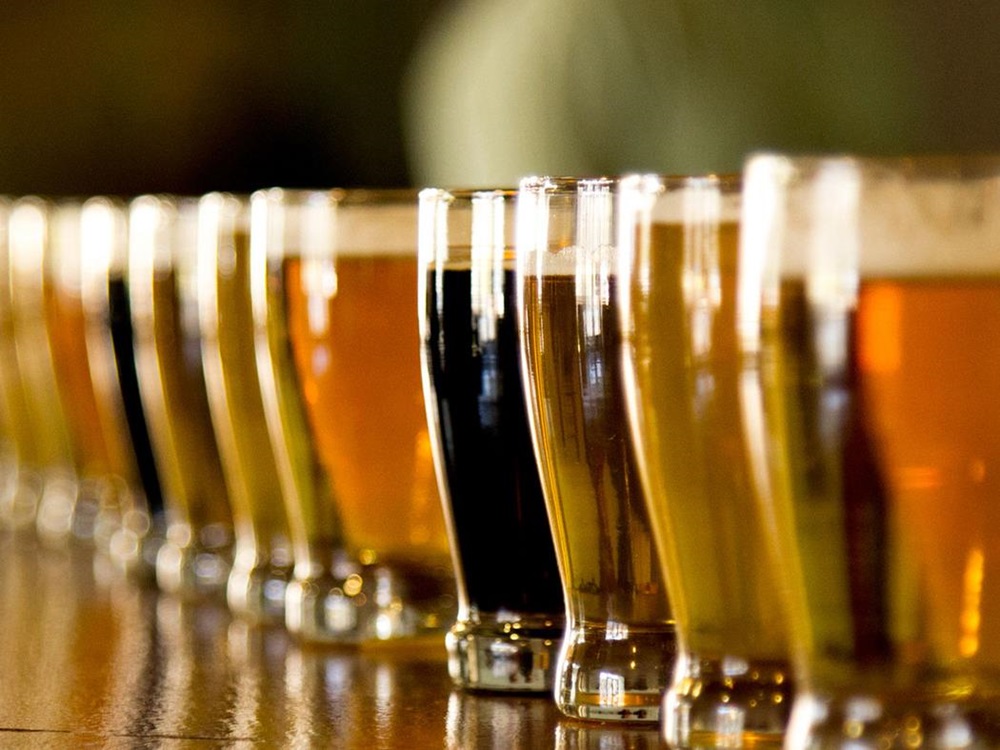 Many Different Glasses of Beer Lined Up on a Bar in San Diego