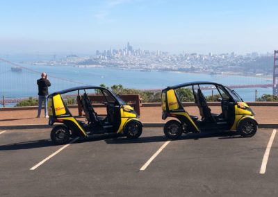 Two GoCars with San Francisco Cityscape in the distance