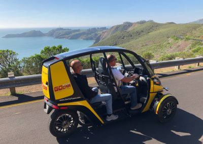 Two GoCar Tourists driving near the Ocean