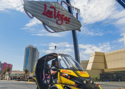 Person sitting in a GoCar under Las Vegas Sign