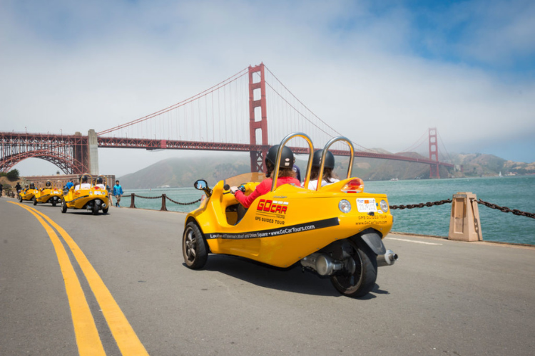 GoCars traveling with the golden gate bridge in the background
