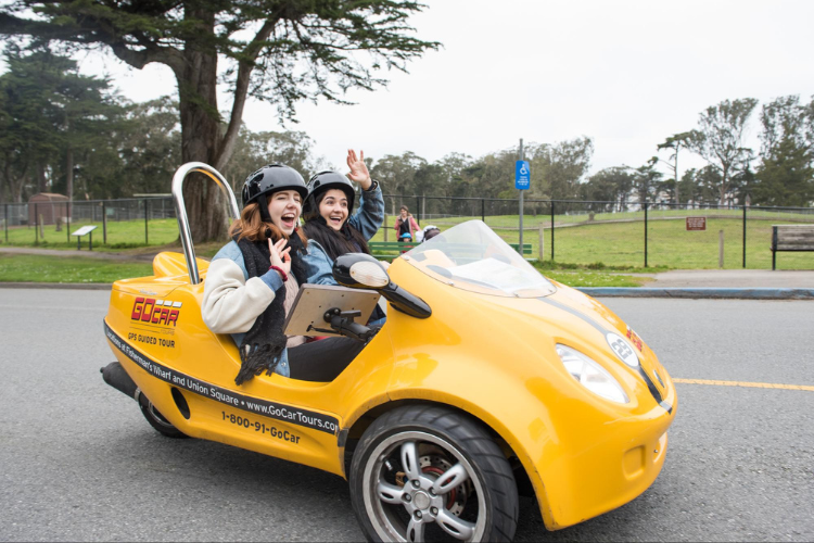 women laughing while riding in a gocar
