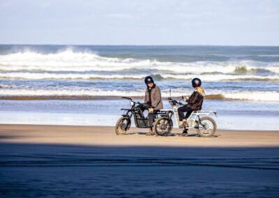 two people on GoRide 2x2 mopeds on the beach