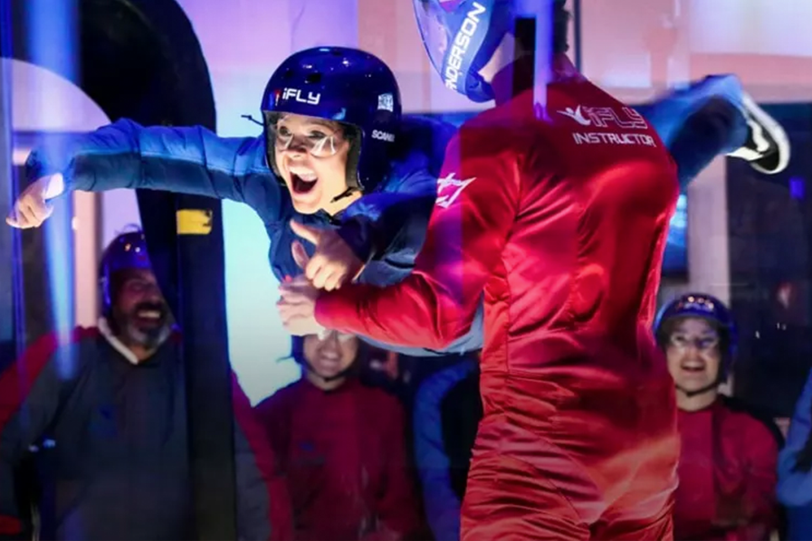 A indoor skydiver and their guide at iFly
