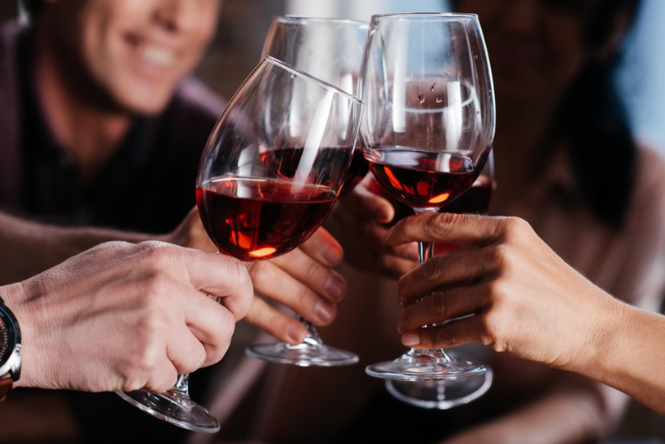 group of people cheers wine