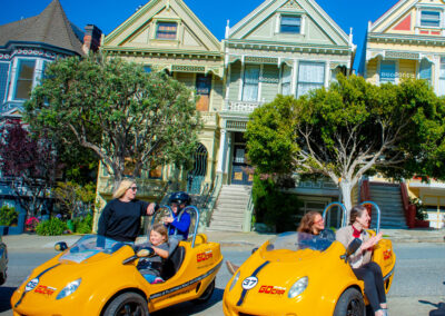 yellow gocars in front of the painted ladies